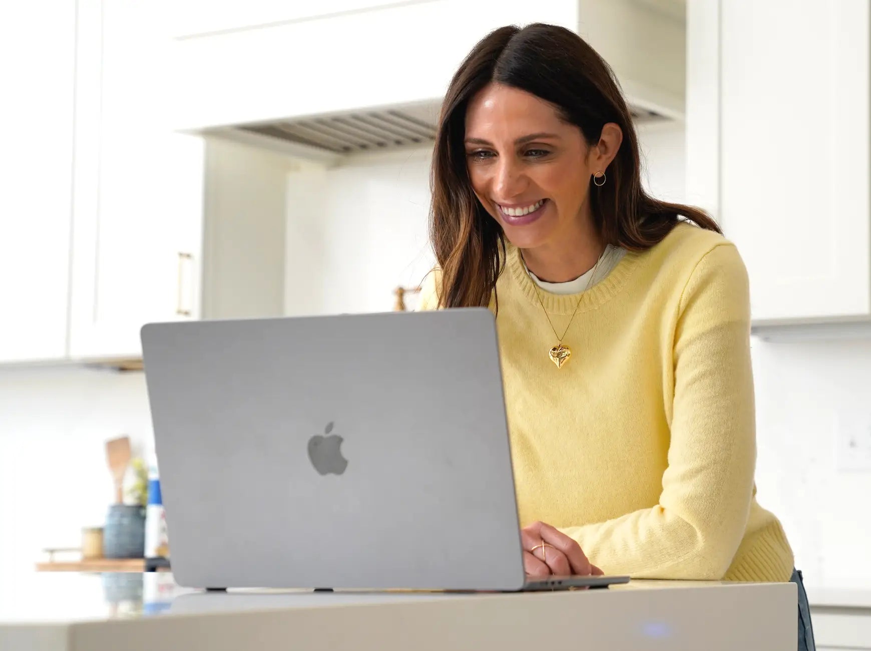 Step 1 of ordering a Reserve Med Supply emergency medication kit, showing a customer completing her medical intake profile on a laptop at a kitchen counter
